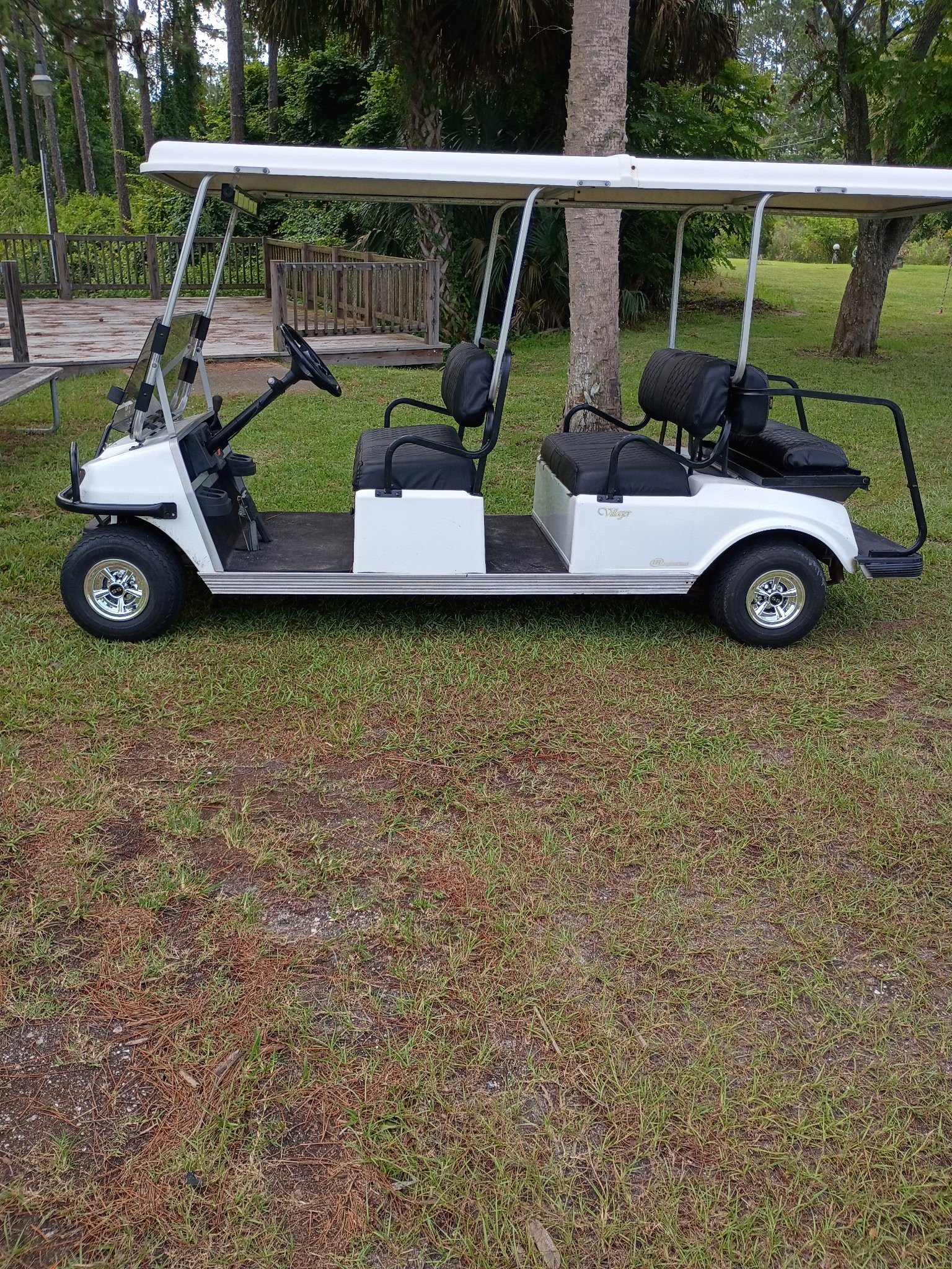 White and black 6-passenger limo golf cart